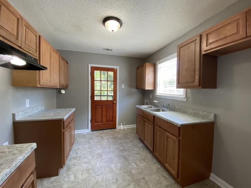 2119 Pendleton Street Memphis, TN 38114 - Photo 8 of 8 a kitchen with stainless steel appliances granite countertop a sink stove and refrigerator