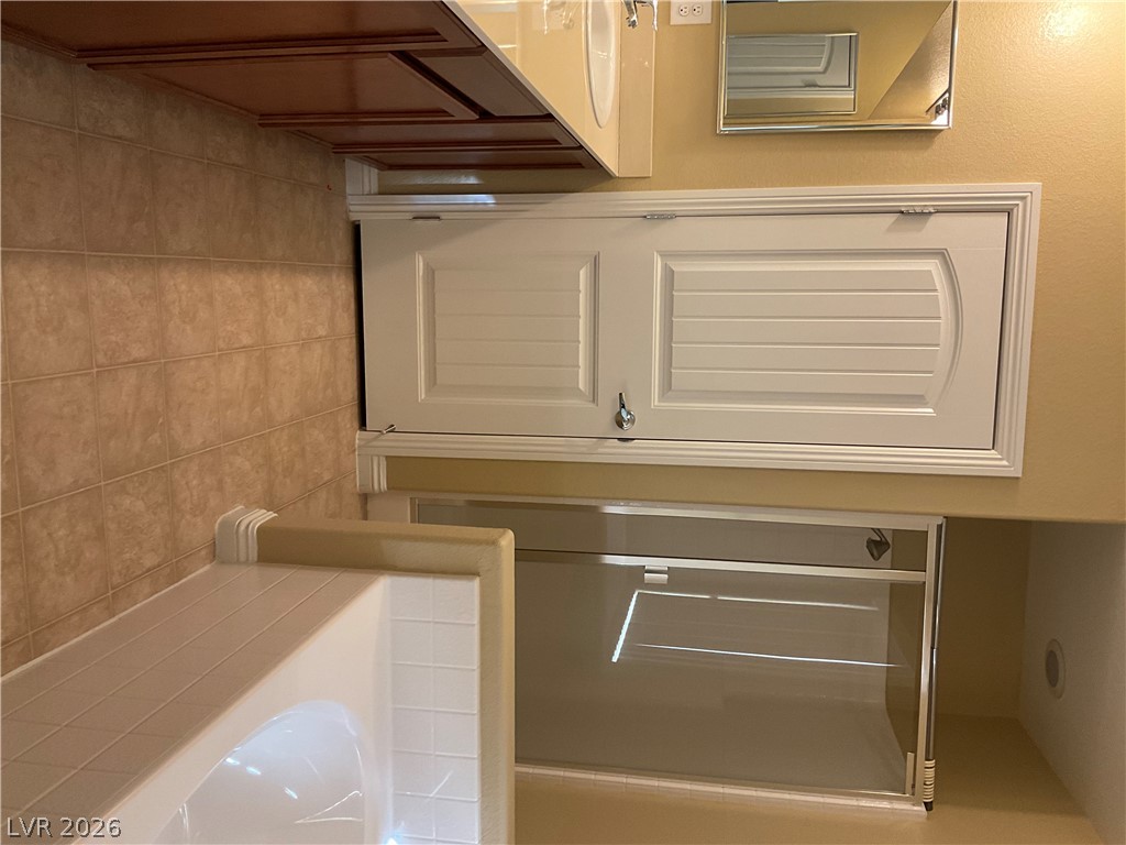 12 Jasmine Point Street Henderson, NV 89074 - Photo 11 of 15 Functional bathroom featuring a shower with a sliding glass door and an elegant vanity.