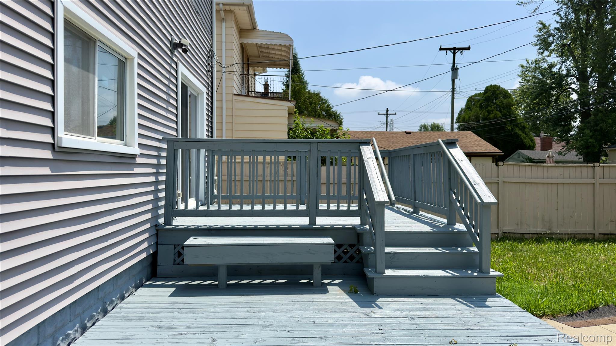 130 Elm Street River Rouge, MI 48218 - Photo 6 of 20 Outdoor deck featuring a built-in bench and stairs leading to a grassy area