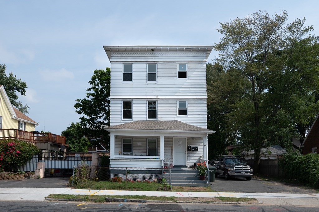 335 Oakland Street Springfield, MA 01108 - Photo 1 of 42 a view of a white house with large windows and plants