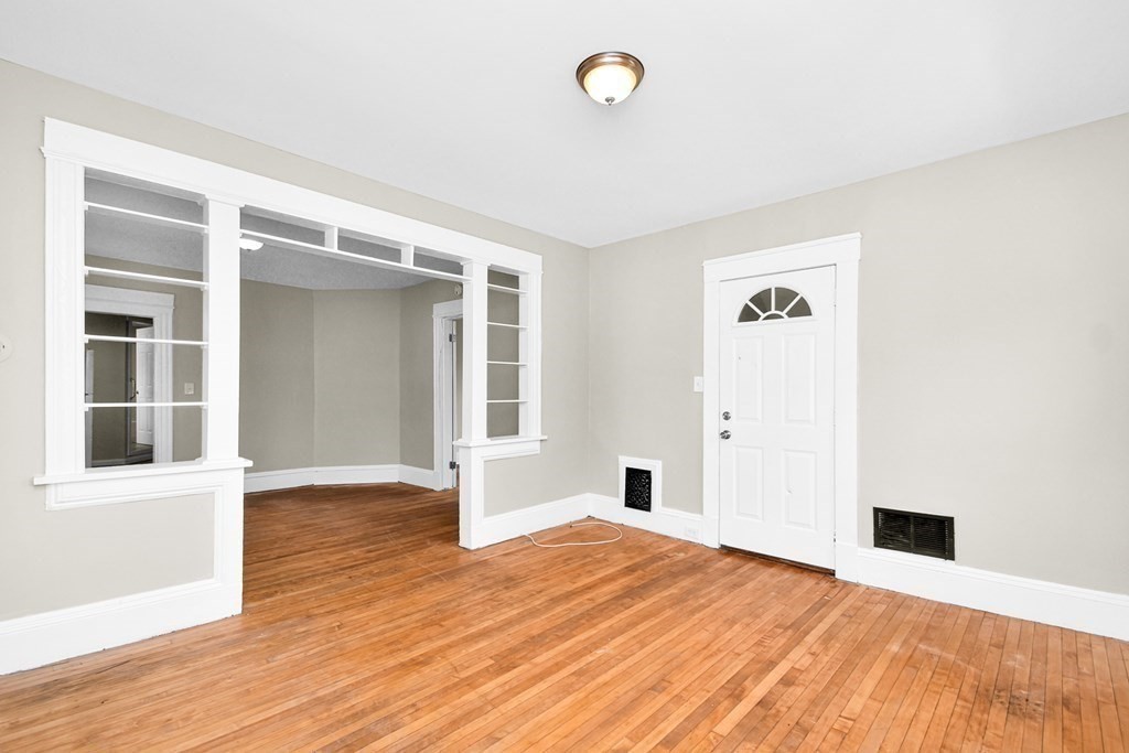 335 Oakland Street Springfield, MA 01108 - Photo 11 of 42 a view of an empty room with wooden floor and a window