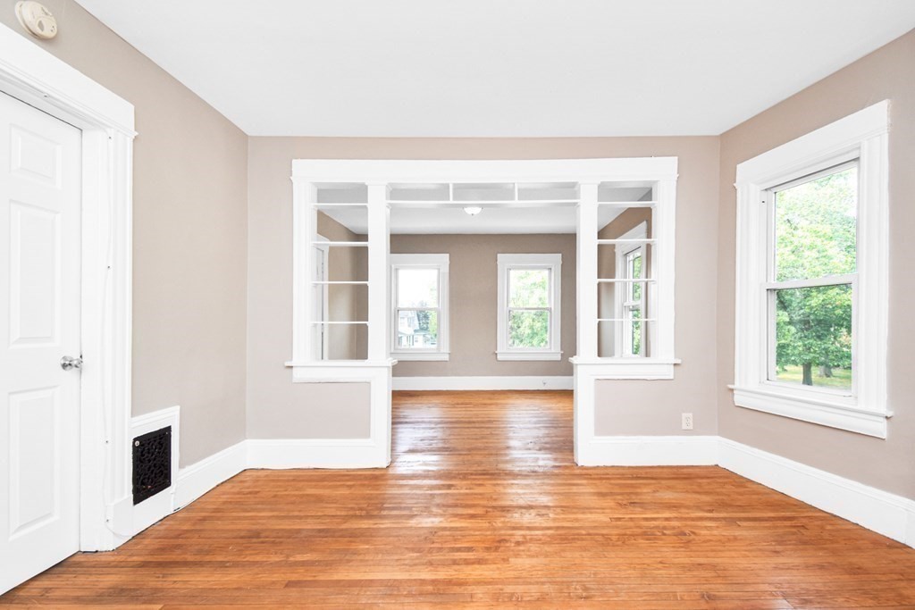 335 Oakland Street Springfield, MA 01108 - Photo 14 of 42 a view of an empty room with window and wooden floor