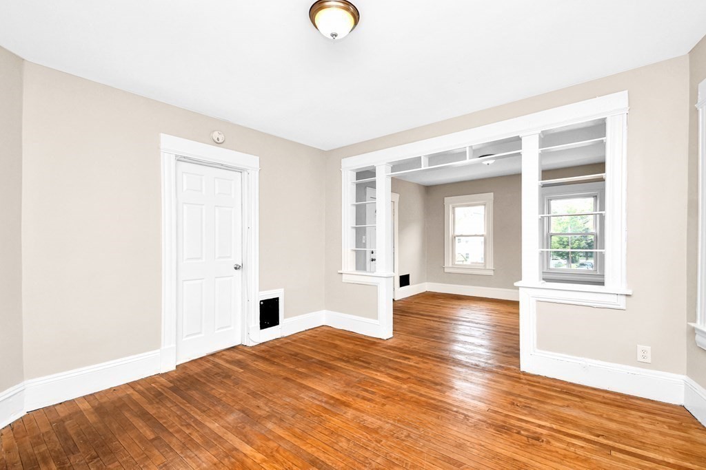 335 Oakland Street Springfield, MA 01108 - Photo 15 of 42 a bedroom with a bed and wooden floor