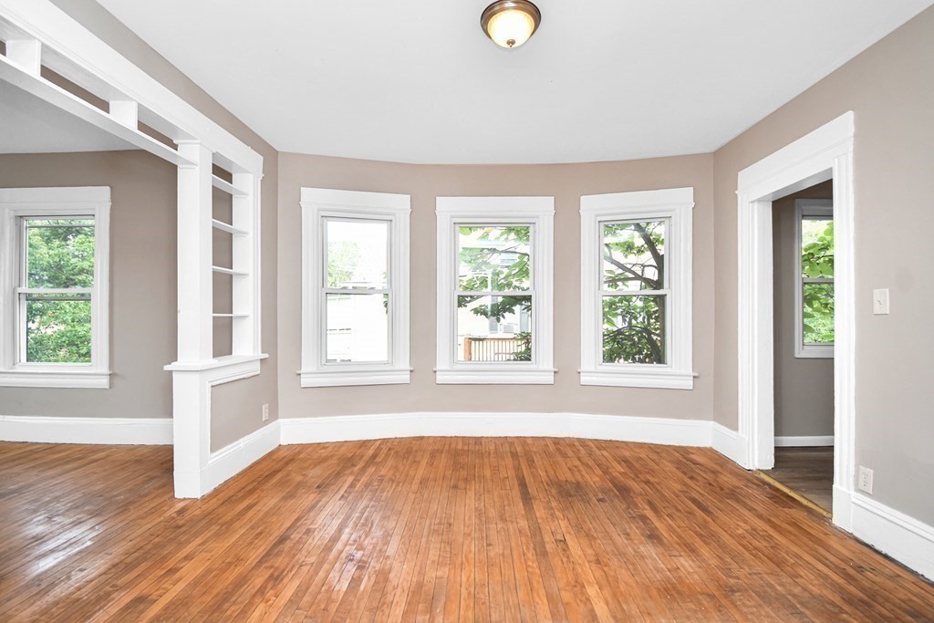 335 Oakland Street Springfield, MA 01108 - Photo 17 of 42 an empty room with wooden floor and windows
