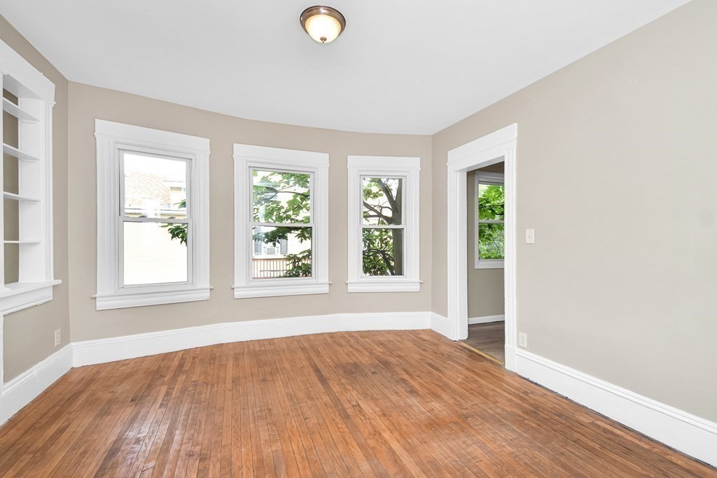 335 Oakland Street Springfield, MA 01108 - Photo 18 of 42 an empty room with wooden floor and windows