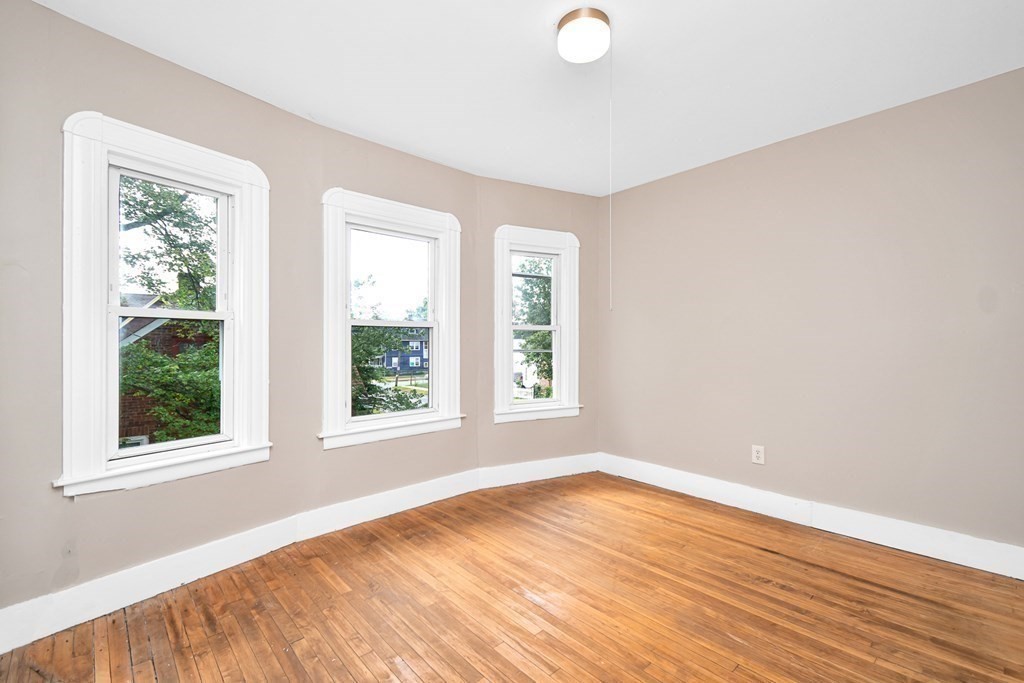 335 Oakland Street Springfield, MA 01108 - Photo 20 of 42 an empty room with wooden floor and windows