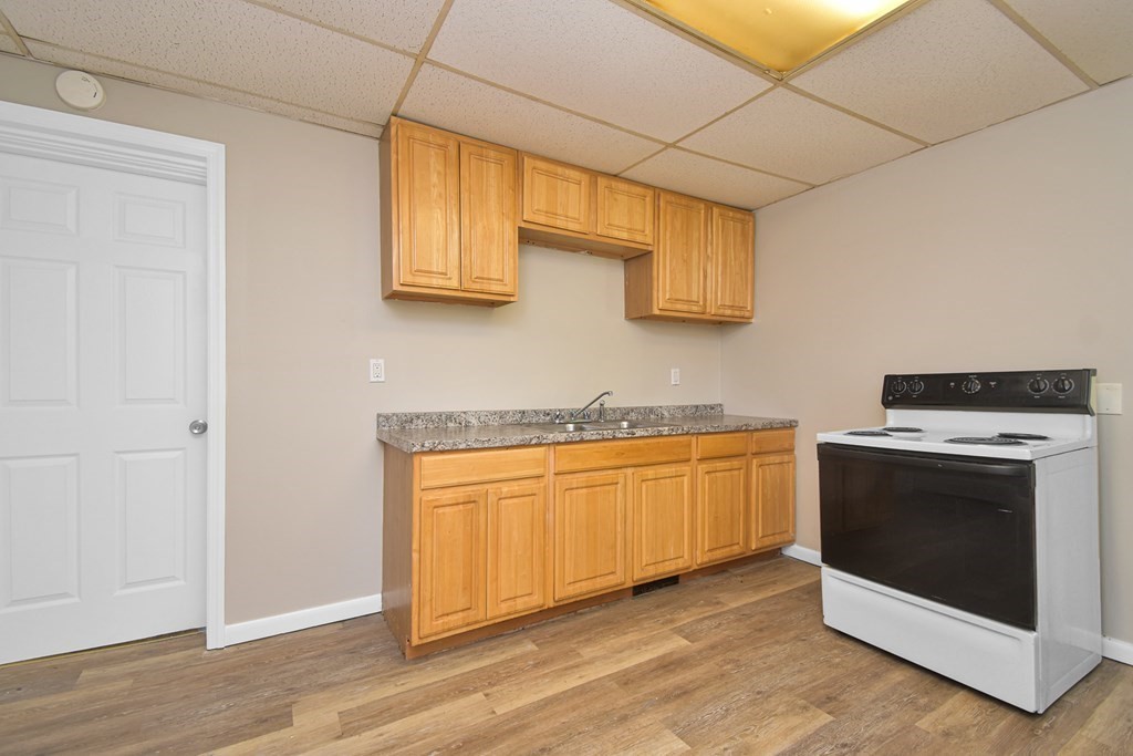 335 Oakland Street Springfield, MA 01108 - Photo 2 of 42 a kitchen with stainless steel appliances granite countertop a stove a sink and a microwave