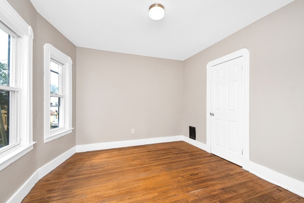 335 Oakland Street Springfield, MA 01108 - Photo 21 of 42 a view of empty room with wooden floor and fan