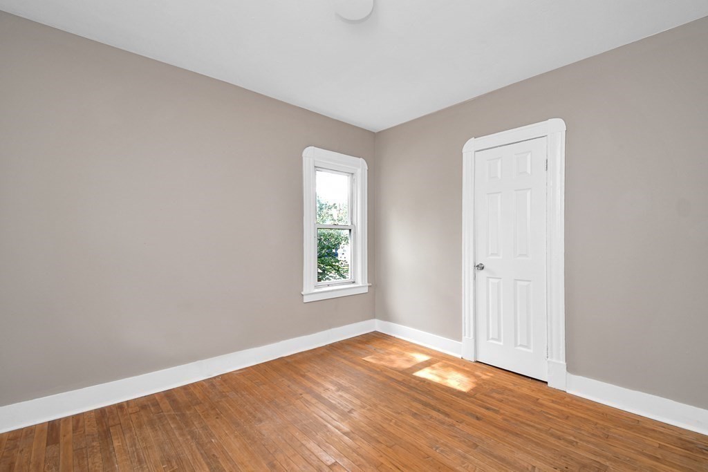 335 Oakland Street Springfield, MA 01108 - Photo 24 of 42 an empty room with wooden floor and windows