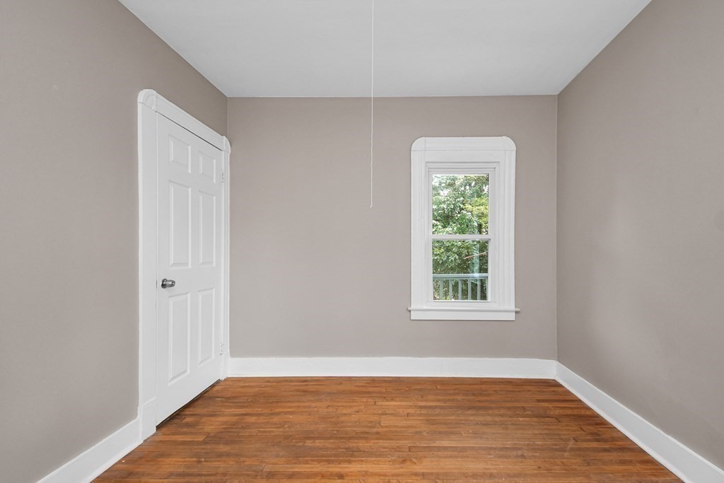 335 Oakland Street Springfield, MA 01108 - Photo 25 of 42 an empty room with wooden floor and windows