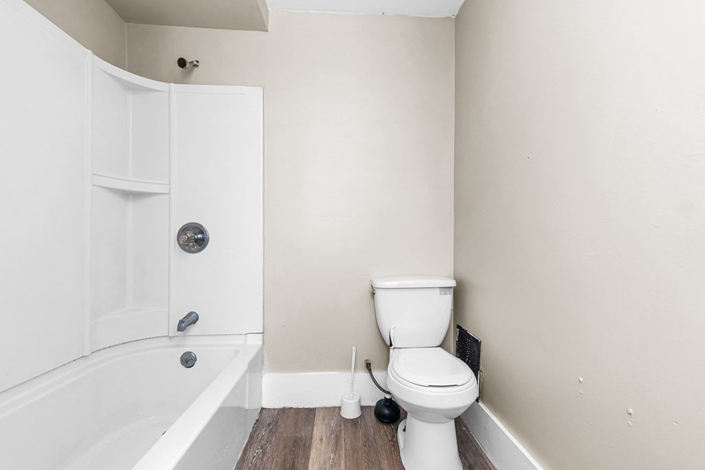 335 Oakland Street Springfield, MA 01108 - Photo 30 of 42 a white toilet sitting next to a bath tub