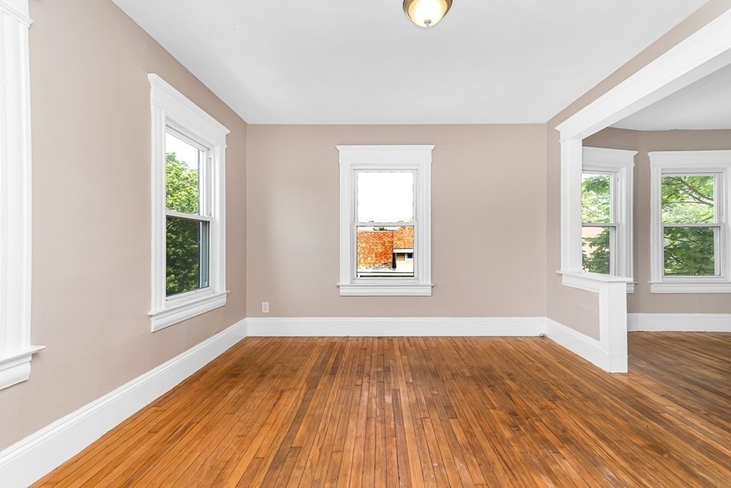 335 Oakland Street Springfield, MA 01108 - Photo 31 of 42 an empty room with wooden floor and windows
