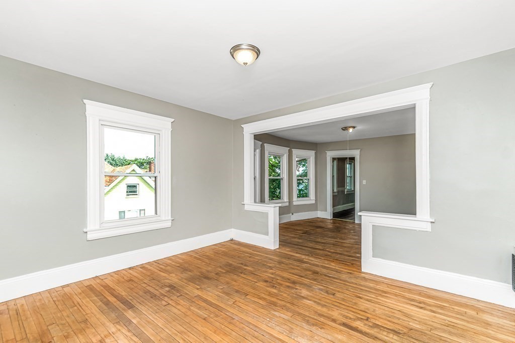 335 Oakland Street Springfield, MA 01108 - Photo 33 of 42 a view of an empty room with wooden floor and a window