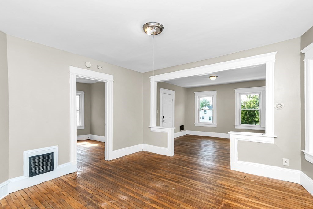 335 Oakland Street Springfield, MA 01108 - Photo 35 of 42 a view of an empty room with wooden floor and a window