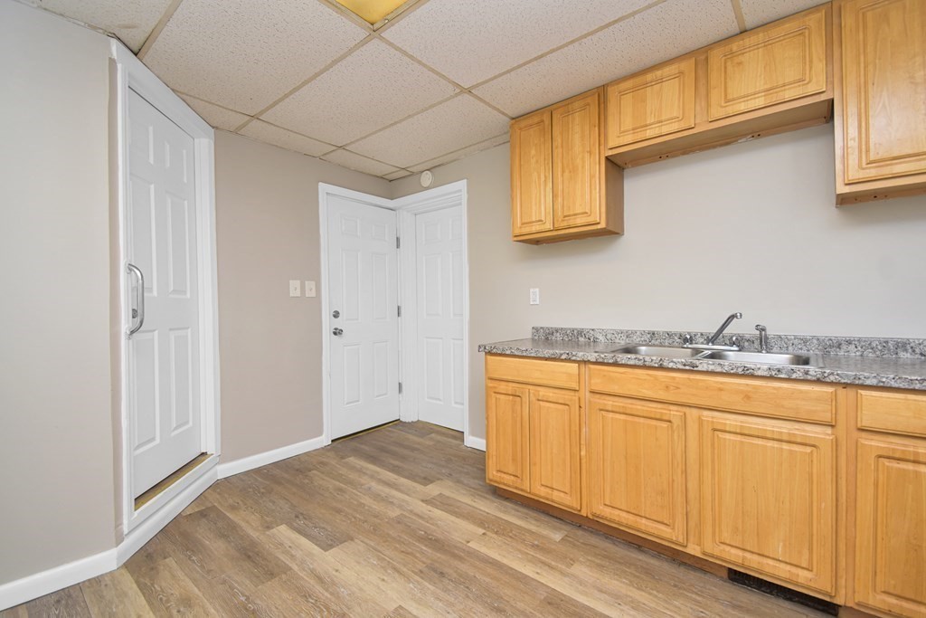 335 Oakland Street Springfield, MA 01108 - Photo 4 of 42 a bathroom with granite countertop white cabinets and a sink