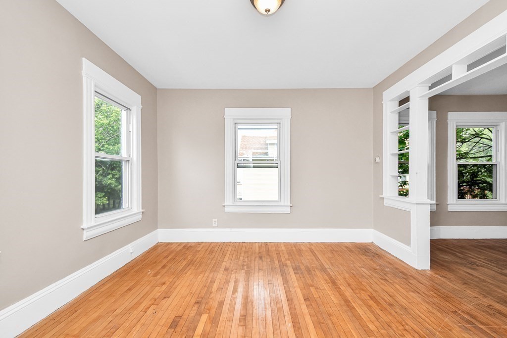 335 Oakland Street Springfield, MA 01108 - Photo 8 of 42 an empty room with wooden floor and windows