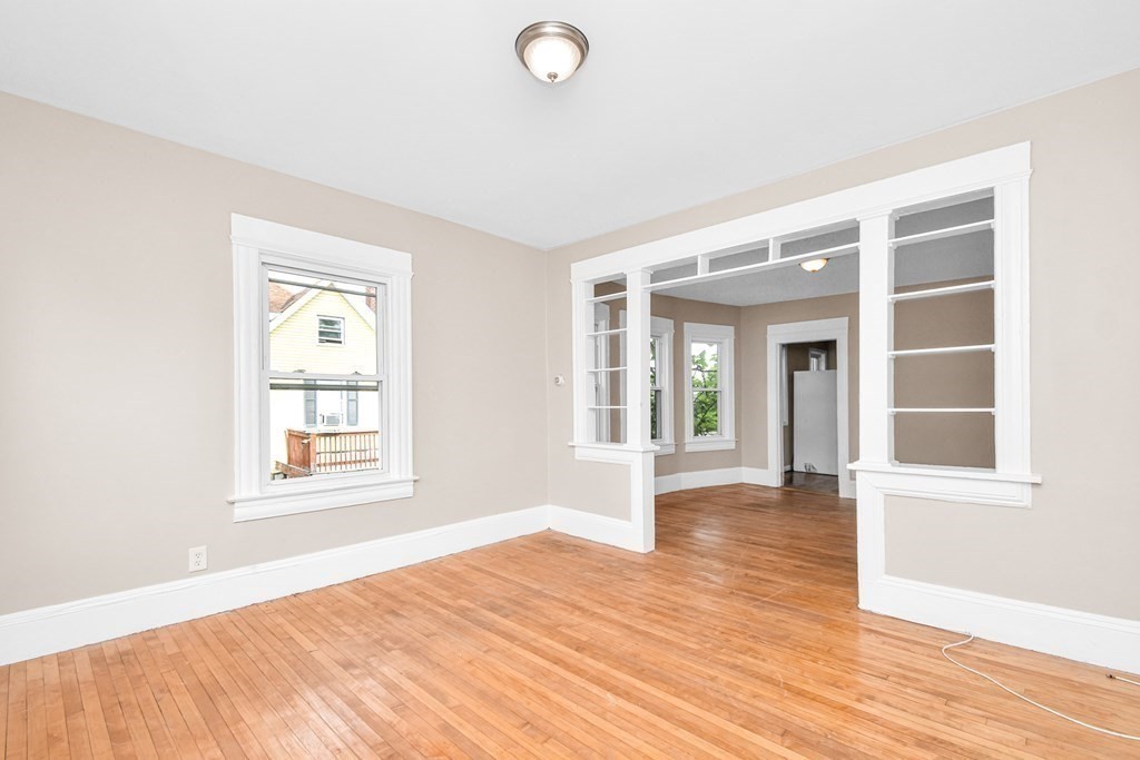 335 Oakland Street Springfield, MA 01108 - Photo 9 of 42 an empty room with wooden floor and windows