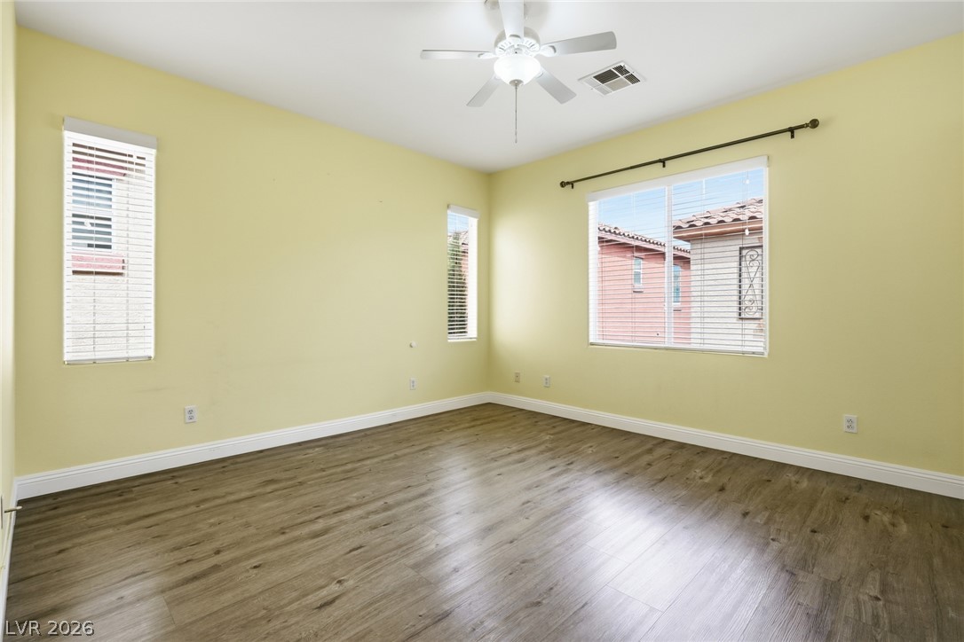 8932 Caledon Ridge Court Las Vegas, NV 89149 - Photo 25 of 39 Gleaming wood-inspired flooring pairs beautifully with multiple windows in this versatile room.