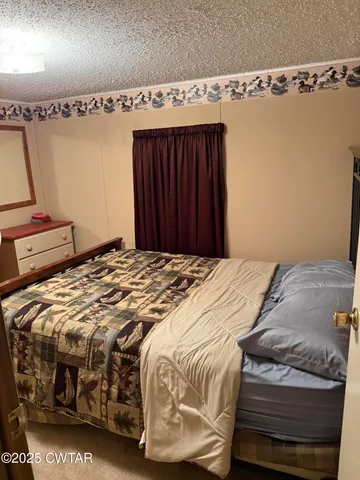 a bedroom with a bed and a mirror