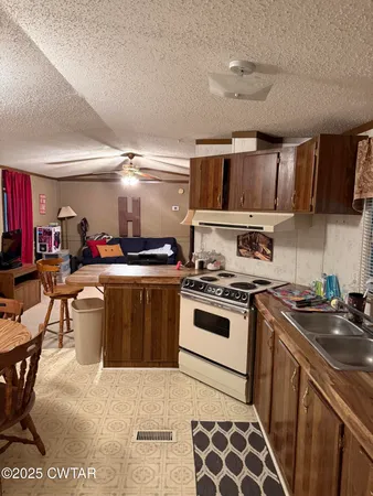 a kitchen with a stove a sink and a refrigerator