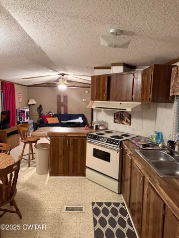 a kitchen with a stove a sink and a refrigerator