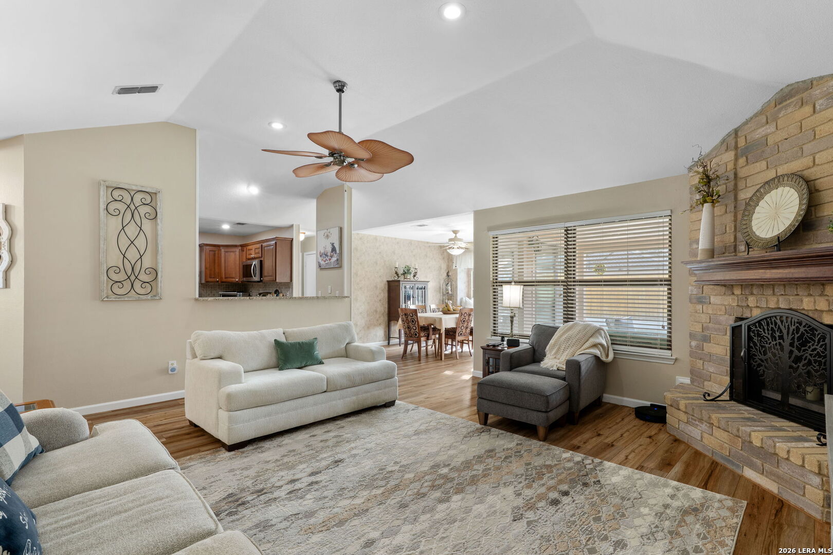 2501 Newning Schertz, TX 78154 - Photo 12 of 28 a living room with furniture a fireplace and a large window