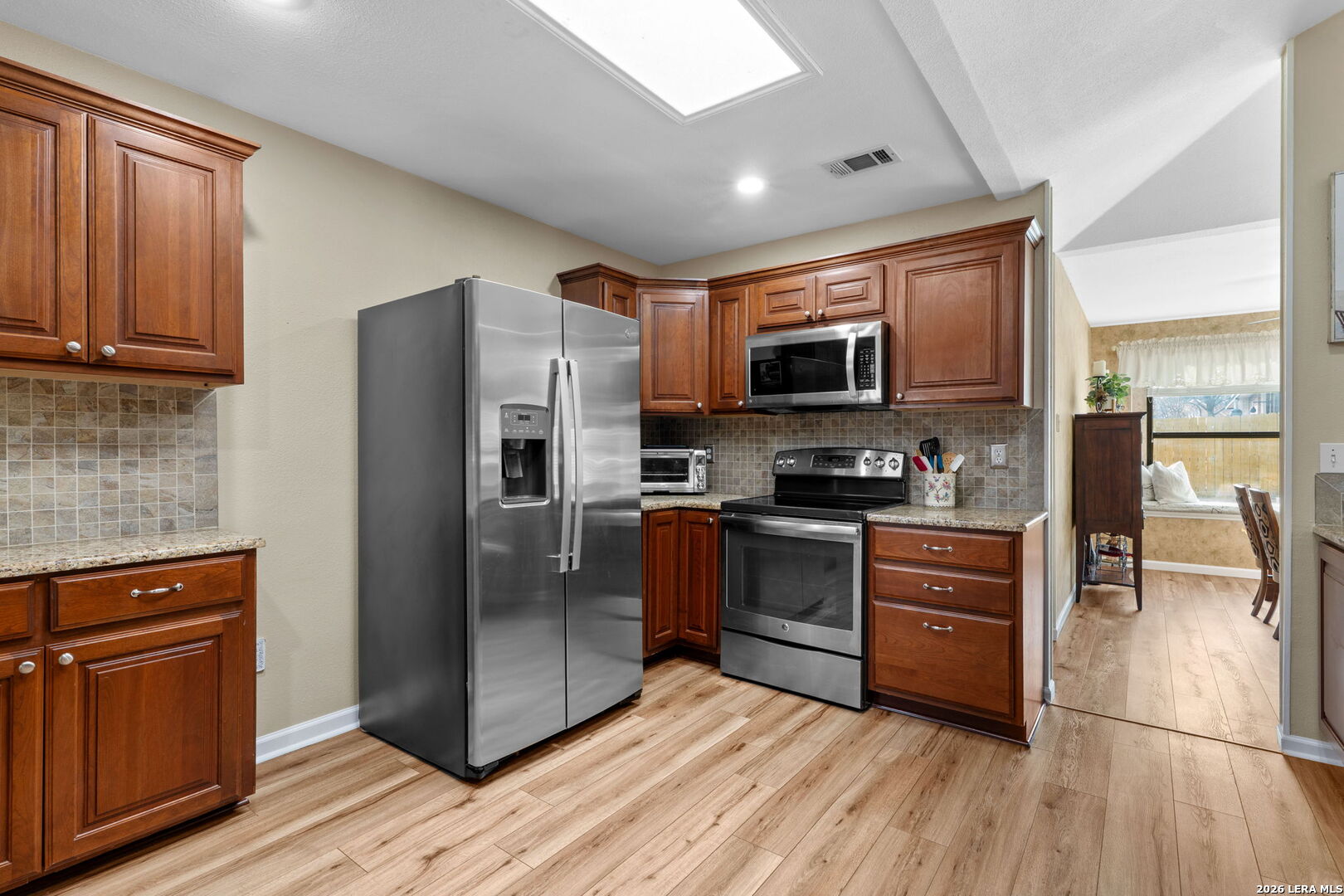 2501 Newning Schertz, TX 78154 - Photo 15 of 28 a kitchen with granite countertop a refrigerator stove and microwave