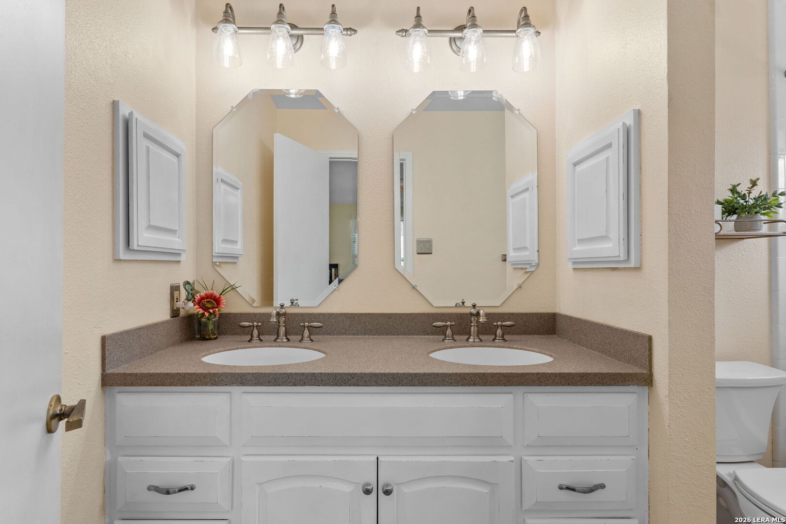 2501 Newning Schertz, TX 78154 - Photo 19 of 28 a bathroom with a double vanity sink and a mirror