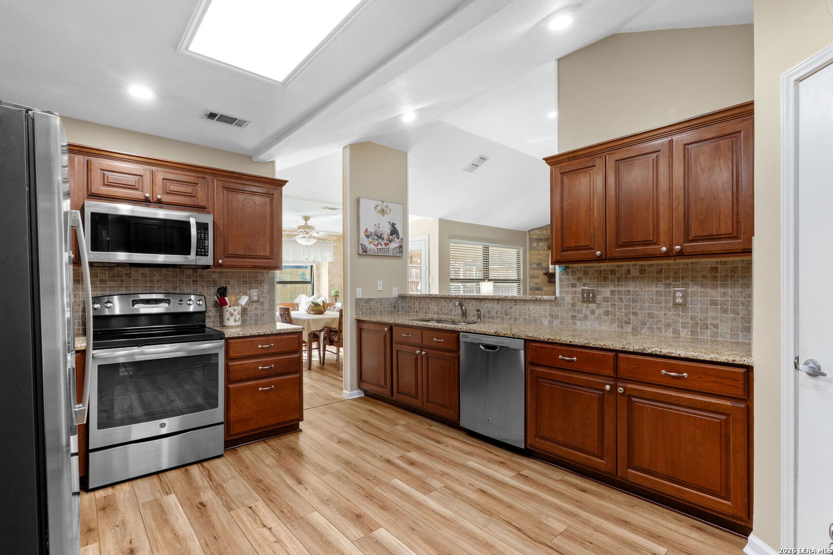2501 Newning Schertz, TX 78154 - Photo 5 of 28 a kitchen with stainless steel appliances granite countertop a stove top oven microwave and cabinets