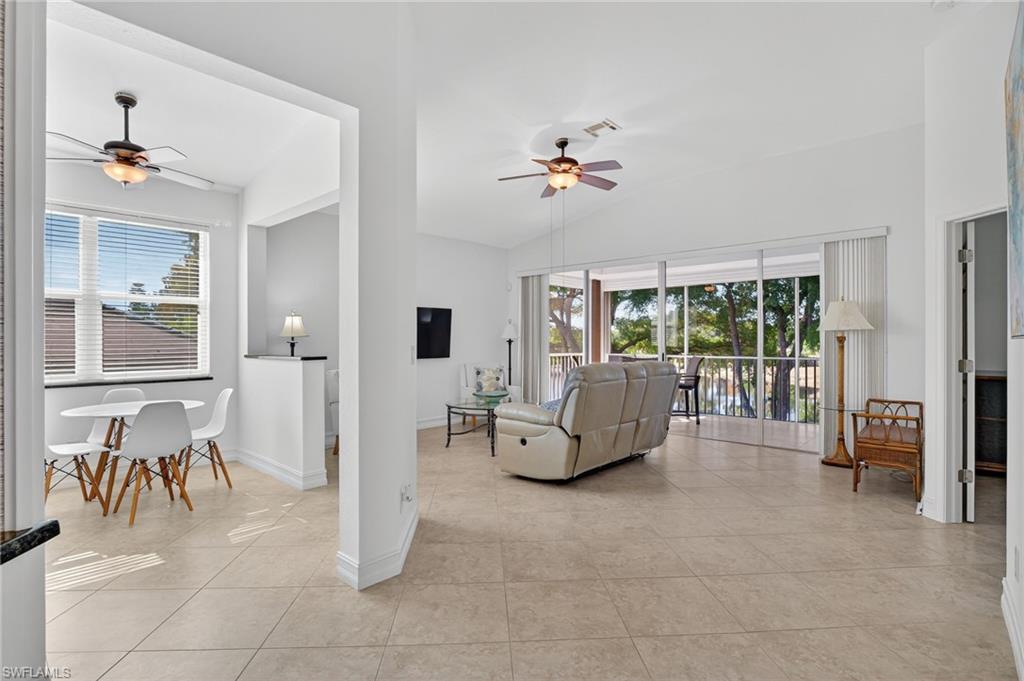 7092 Timberland Circle, Unit 201 Naples, FL 34109 - Photo 13 of 43 a living room with furniture and a window