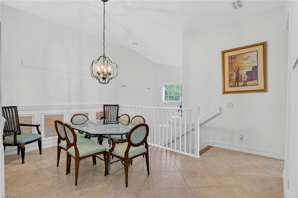 7092 Timberland Circle, Unit 201 Naples, FL 34109 - Photo 17 of 43 a view of a dining room with furniture and chandelier