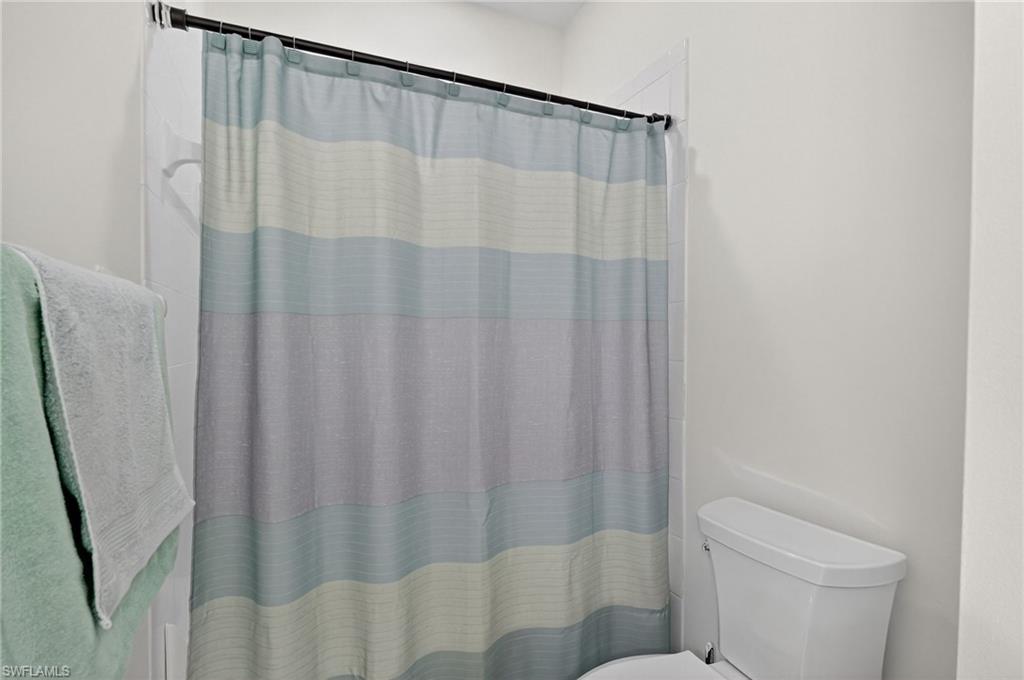 7092 Timberland Circle, Unit 201 Naples, FL 34109 - Photo 26 of 43 a bathroom with a shower and a toilet