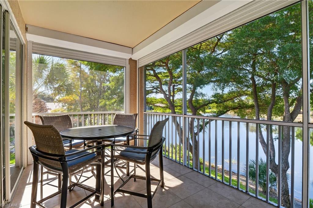 7092 Timberland Circle, Unit 201 Naples, FL 34109 - Photo 3 of 43 a view of a balcony with furniture and garden