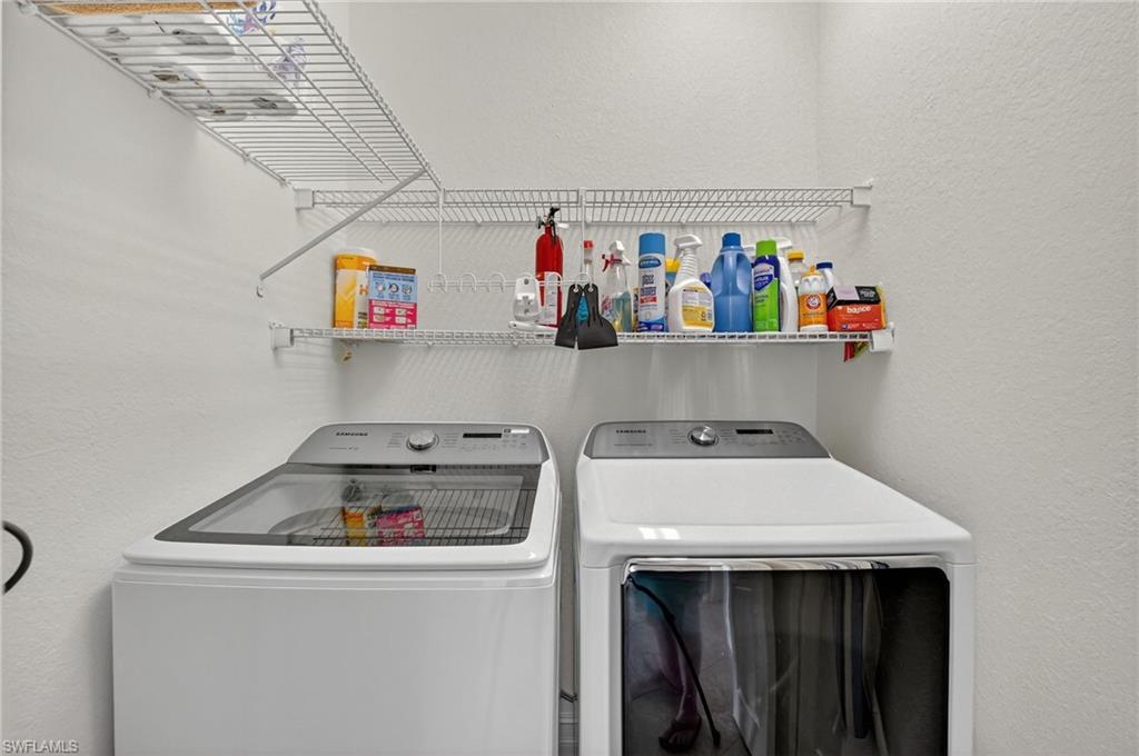 7092 Timberland Circle, Unit 201 Naples, FL 34109 - Photo 31 of 43 a utility room with dryer and washer
