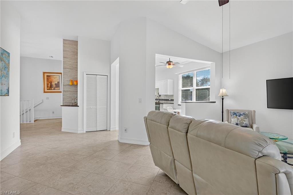 7092 Timberland Circle, Unit 201 Naples, FL 34109 - Photo 33 of 43 a living room with furniture and a flat screen tv