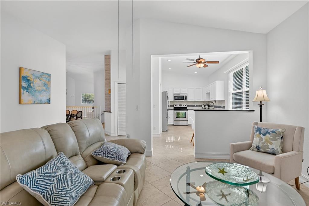 7092 Timberland Circle, Unit 201 Naples, FL 34109 - Photo 34 of 43 a living room with furniture and wooden floor