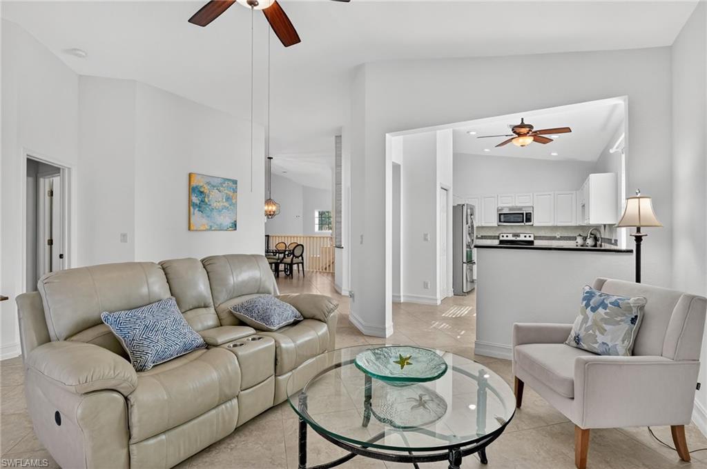 7092 Timberland Circle, Unit 201 Naples, FL 34109 - Photo 35 of 43 a living room with furniture and kitchen view