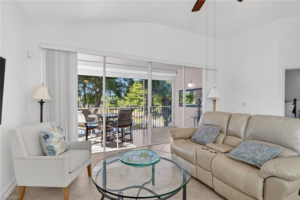 7092 Timberland Circle, Unit 201 Naples, FL 34109 - Photo 36 of 43 a living room with furniture and a large window