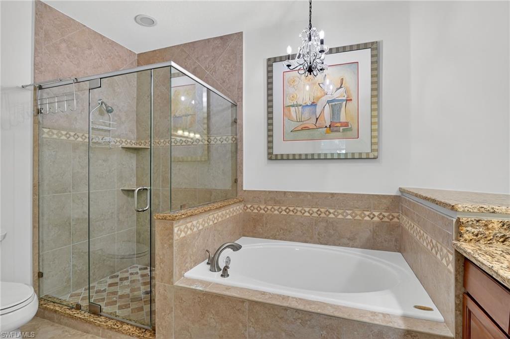 7092 Timberland Circle, Unit 201 Naples, FL 34109 - Photo 39 of 43 a bathroom with a tub and a shower