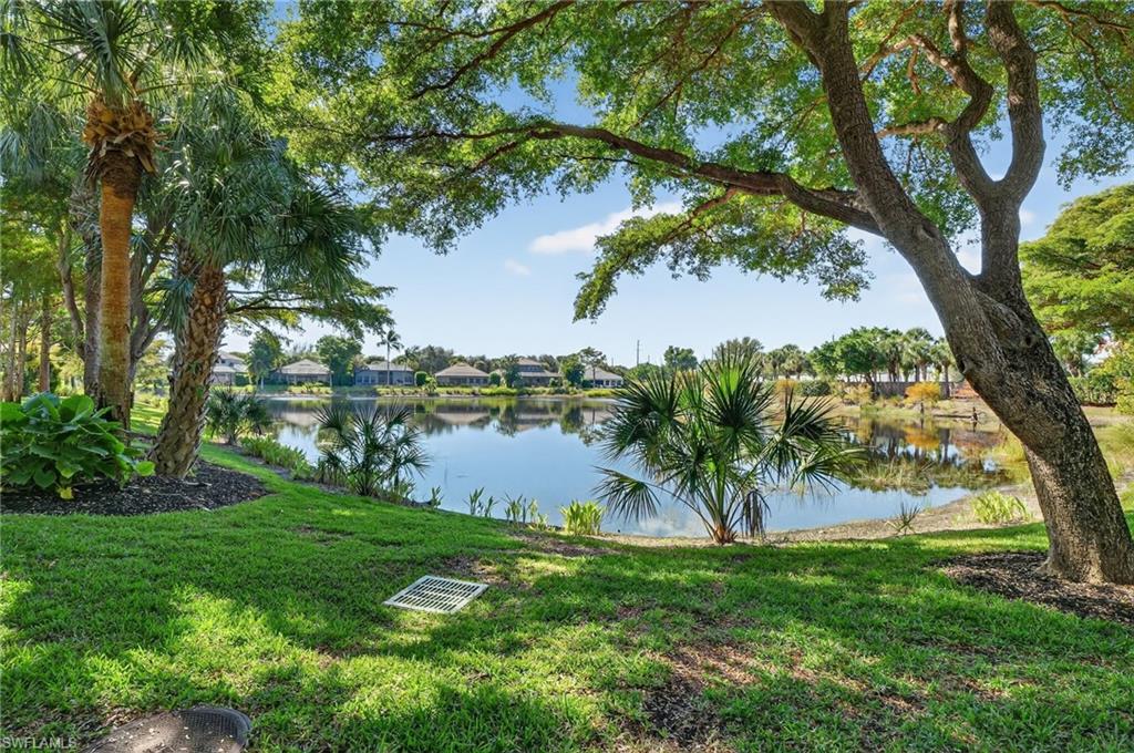 7092 Timberland Circle, Unit 201 Naples, FL 34109 - Photo 4 of 43 a view of a lake from a yard