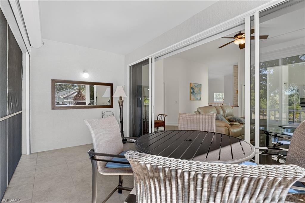 7092 Timberland Circle, Unit 201 Naples, FL 34109 - Photo 42 of 43 a bedroom with a large bed and a window