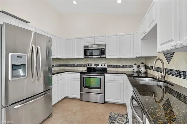 a kitchen with a refrigerator stove and microwave