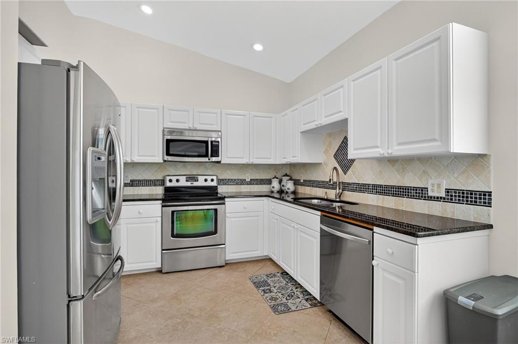 7092 Timberland Circle, Unit 201 Naples, FL 34109 - Photo 8 of 43 a kitchen with a refrigerator stove and microwave
