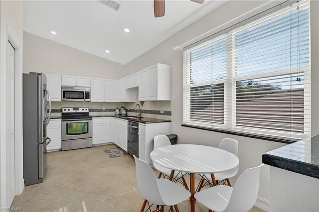 a view of a dining room with furniture and a window