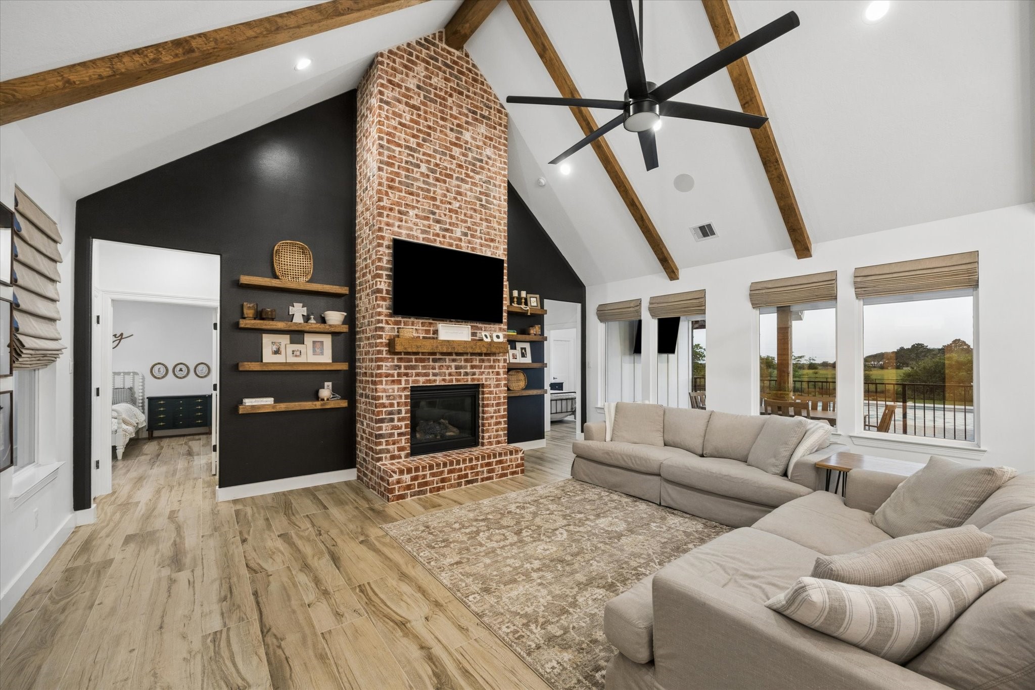 5131 Timber Ridge Drive Sealy, TX 77474 - Photo 11 of 50 Exposed wooden beams, brick fireplace, large windows with a view to the stunning back yard.
