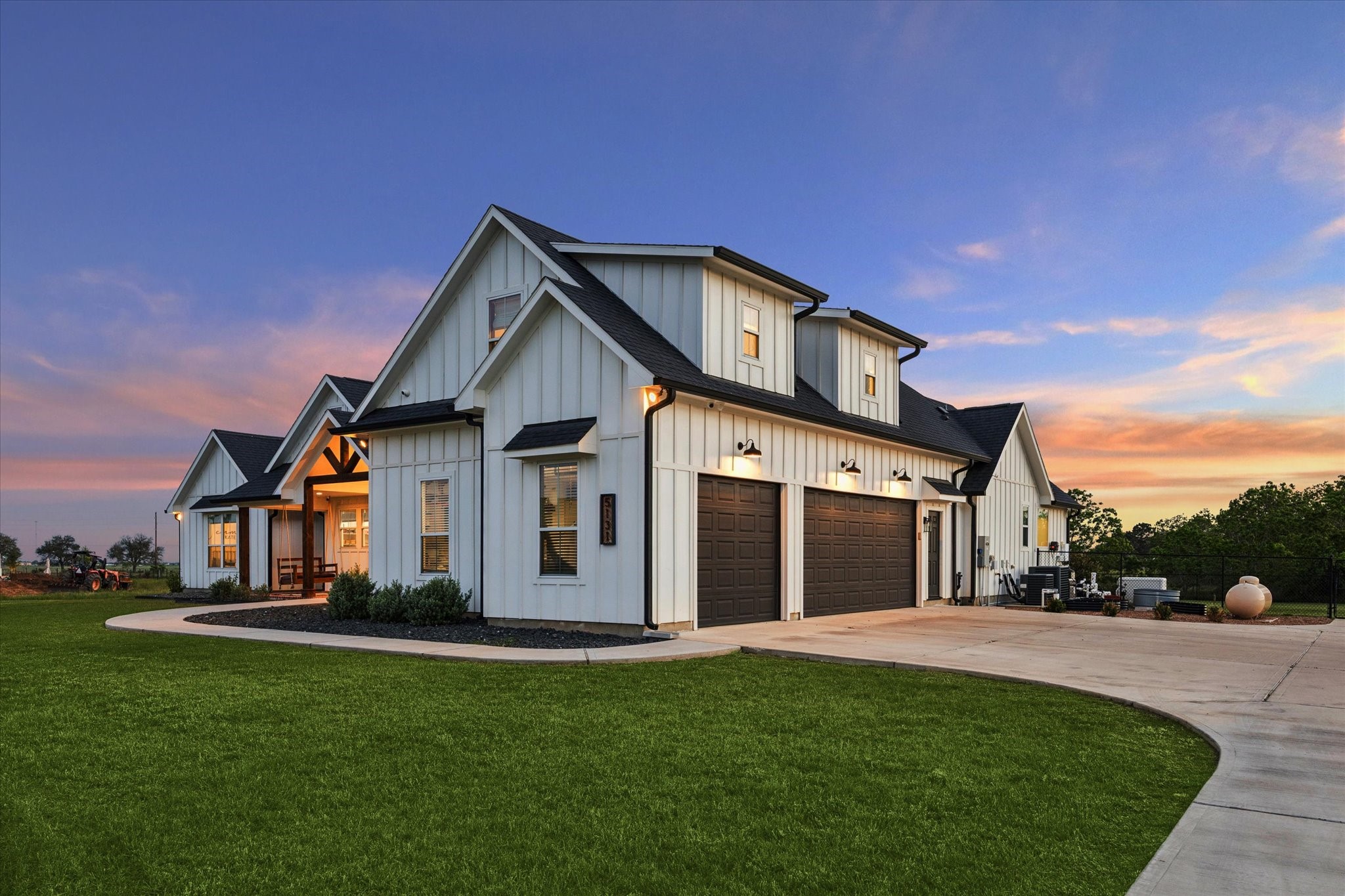 5131 Timber Ridge Drive Sealy, TX 77474 - Photo 2 of 50 This modern farmhouse features a spacious 2 1/2 car garage, elegant white siding with contrasting dark roof and trim, and a welcoming front porch.