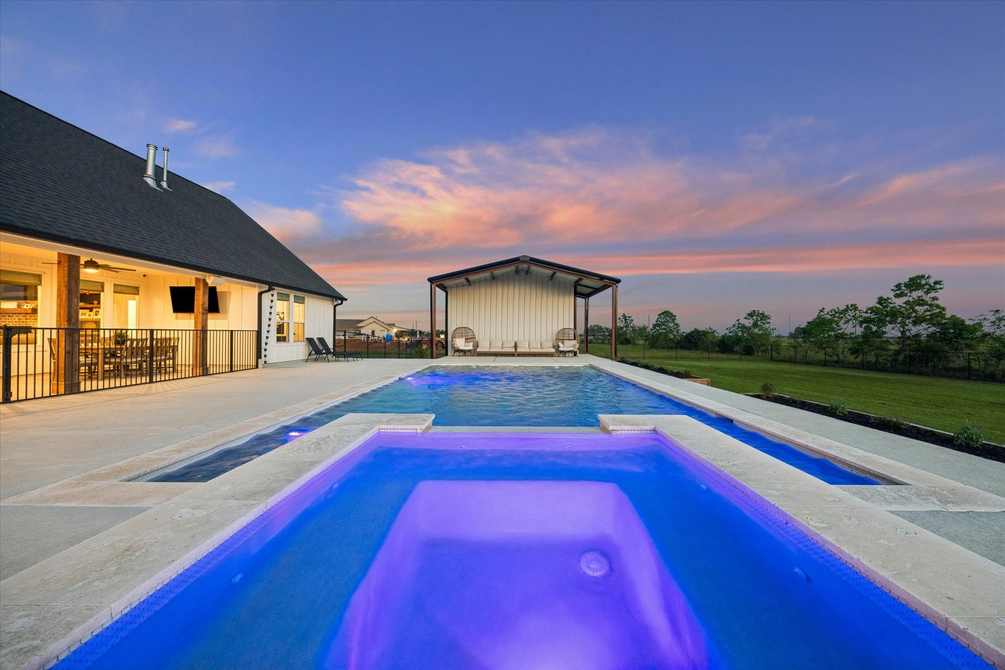 5131 Timber Ridge Drive Sealy, TX 77474 - Photo 43 of 50 This stunning property features a pool with ambient lighting and spacious patio, offering a perfect blend of luxury and tranquility.