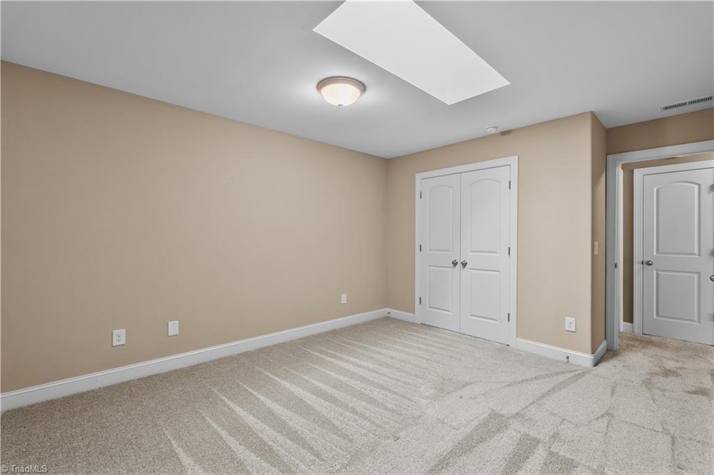 654 Nikyle Circle High Point, NC 27265 - Photo 36 of 40 Third Bedroom Upstairs w Skylight