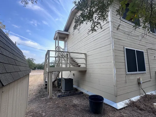 a view of a terrace with a table and chairs