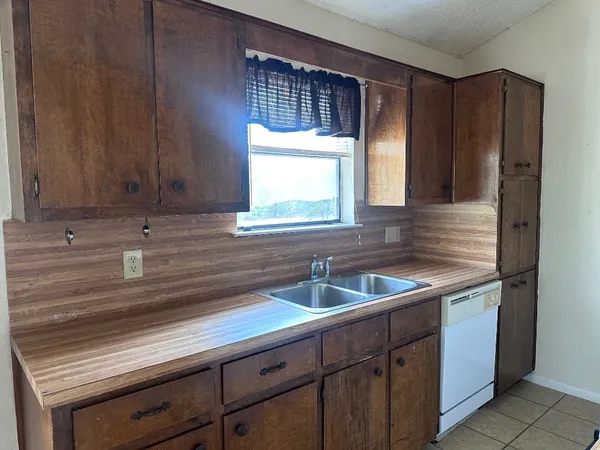 a kitchen with a sink and cabinets